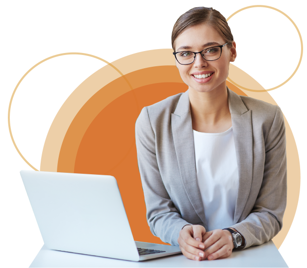 Mujer joven con lentes sentada sonriente viendo de frente junto a su laptop   